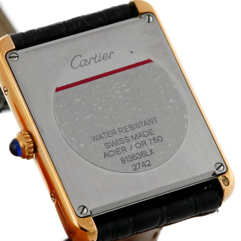 The image shows the back of a Cartier Tank Solo W1018855 Men
s Steel and Gold (two tone) Silver Dial W1018855 Men
s Steel and Gold (two tone) Silver Dial watch, including details of its water resistance and Swiss-made label.