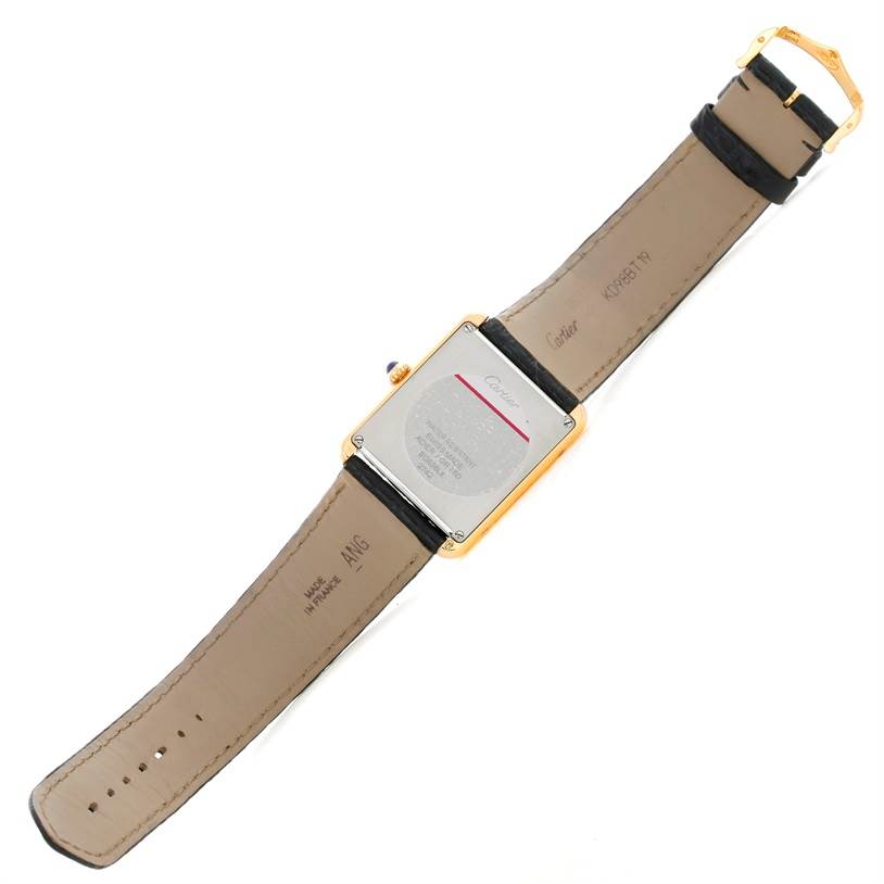 The image shows the back of a Tank Solo model watch by Cartier, focusing on the case back and leather strap.