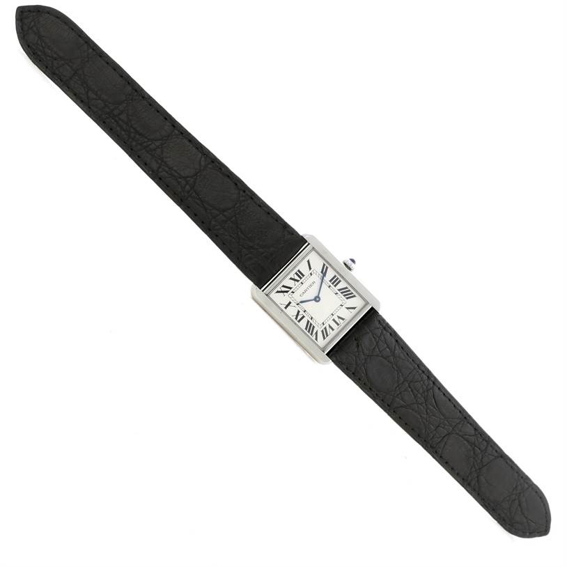 The Cartier Tank Solo W1018355 Men
s Stainless Steel Silver Dial W1018355 Men
s Stainless Steel Silver Dial watch is displayed from a top-down angle, showing its face and black leather strap.