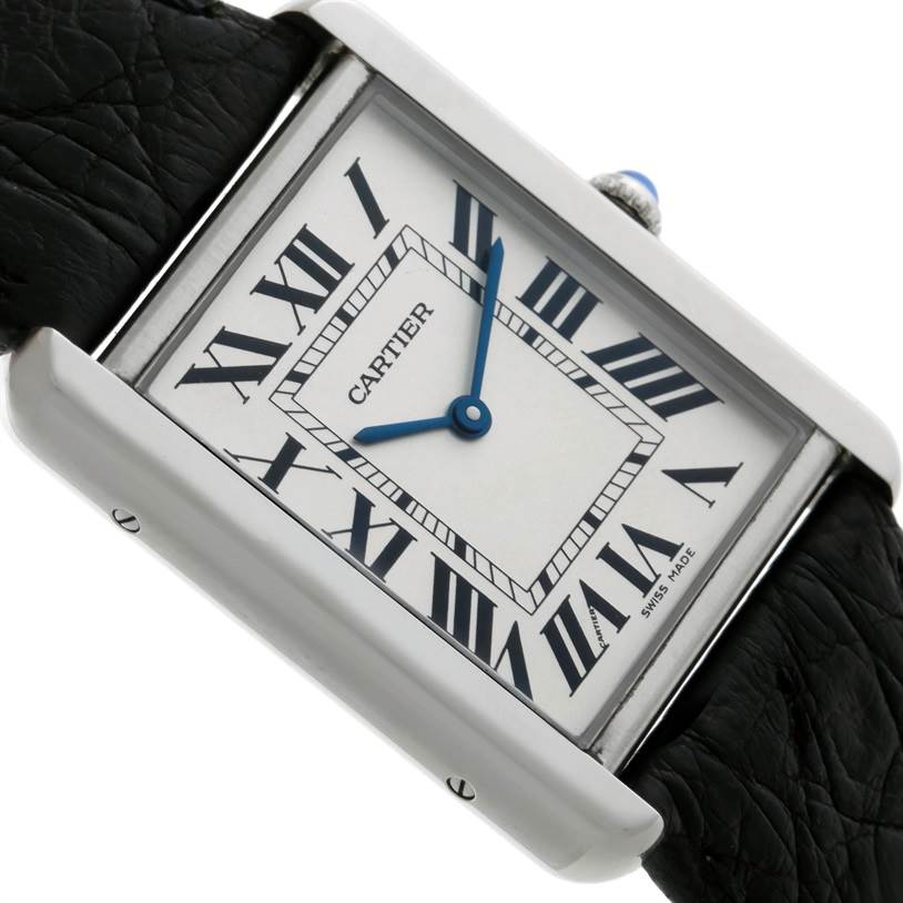 The image shows a close-up, angled view of the Cartier Tank Solo W1018355 Men
s Stainless Steel Silver Dial W1018355 Men
s Stainless Steel Silver Dial watch face, highlighting its Roman numerals and blue hands.