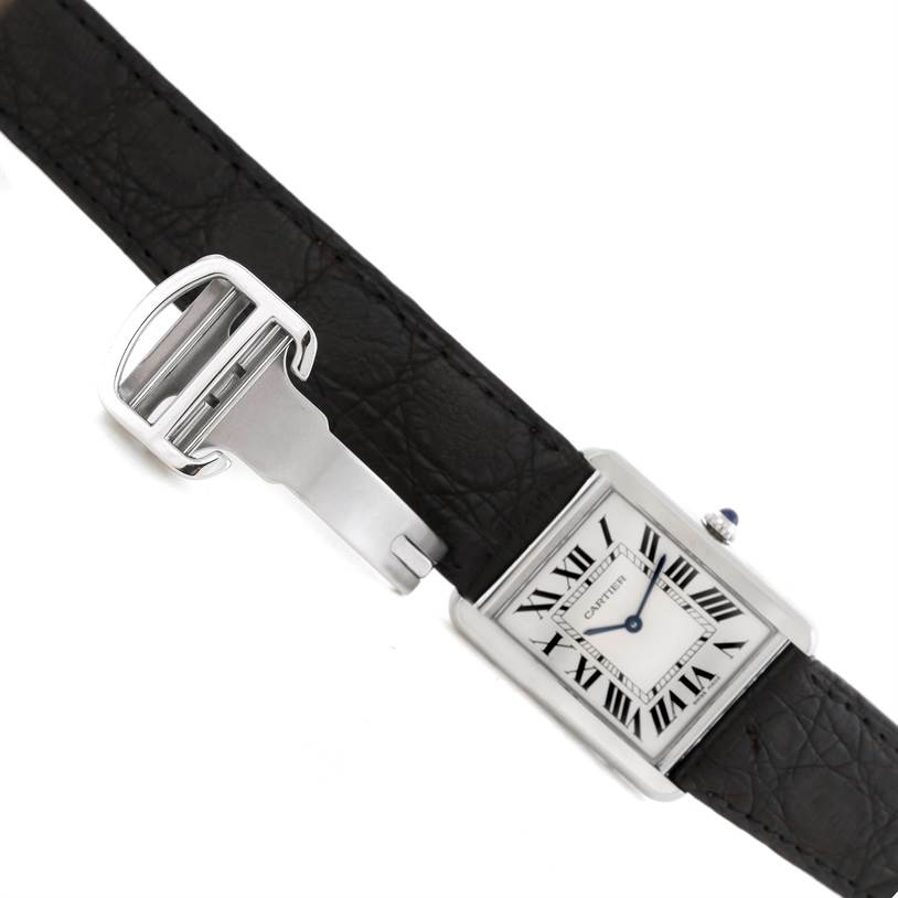 This image shows a Cartier Tank Solo W1018355 Men
s Stainless Steel Silver Dial W1018355 Men
s Stainless Steel Silver Dial watch with a close-up of its face, crown, black leather strap, and deployment clasp.