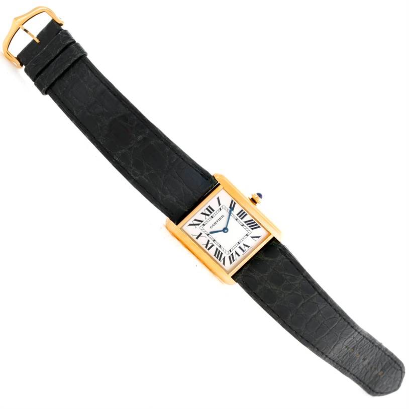 The image shows a Cartier Tank Solo W1018855 Men
s Steel and Gold (two tone) Silver Dial W1018855 Men
s Steel and Gold (two tone) Silver Dial watch laid flat, displaying its rectangular face and black leather strap.