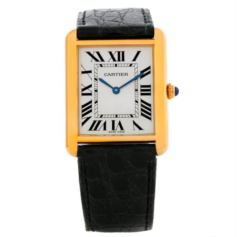 The image shows a front view of a Cartier Tank Solo W1018855 Men
s Steel and Gold (two tone) Silver Dial W1018855 Men
s Steel and Gold (two tone) Silver Dial watch, highlighting its gold rectangular case, white dial with Roman numerals, and black leather strap.