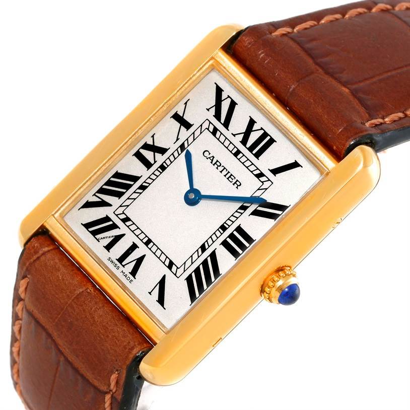 The Cartier Tank Solo W1018855 Men
s Steel and Gold (two tone) Silver Dial W1018855 Men
s Steel and Gold (two tone) Silver Dial watch is shown from an angled view, highlighting its rectangular case, Roman numeral dial, and brown leather strap.