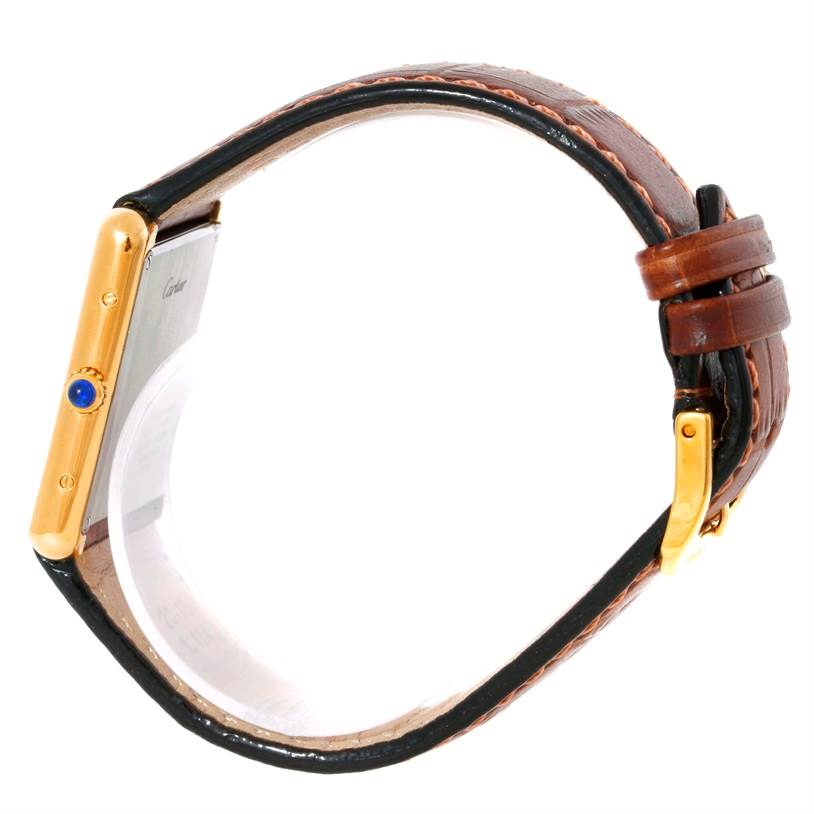 The image shows a Cartier Tank Solo W1018855 Men
s Steel and Gold (two tone) Silver Dial W1018855 Men
s Steel and Gold (two tone) Silver Dial watch from a side angle, focusing on the watch case, crown, and leather strap with buckle.