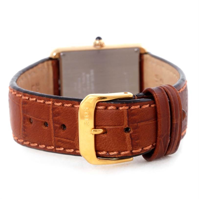 The image shows the back and buckle of a Cartier Tank Solo W1018855 Men
s Steel and Gold (two tone) Silver Dial W1018855 Men
s Steel and Gold (two tone) Silver Dial watch, highlighting its brown leather strap and gold clasp.