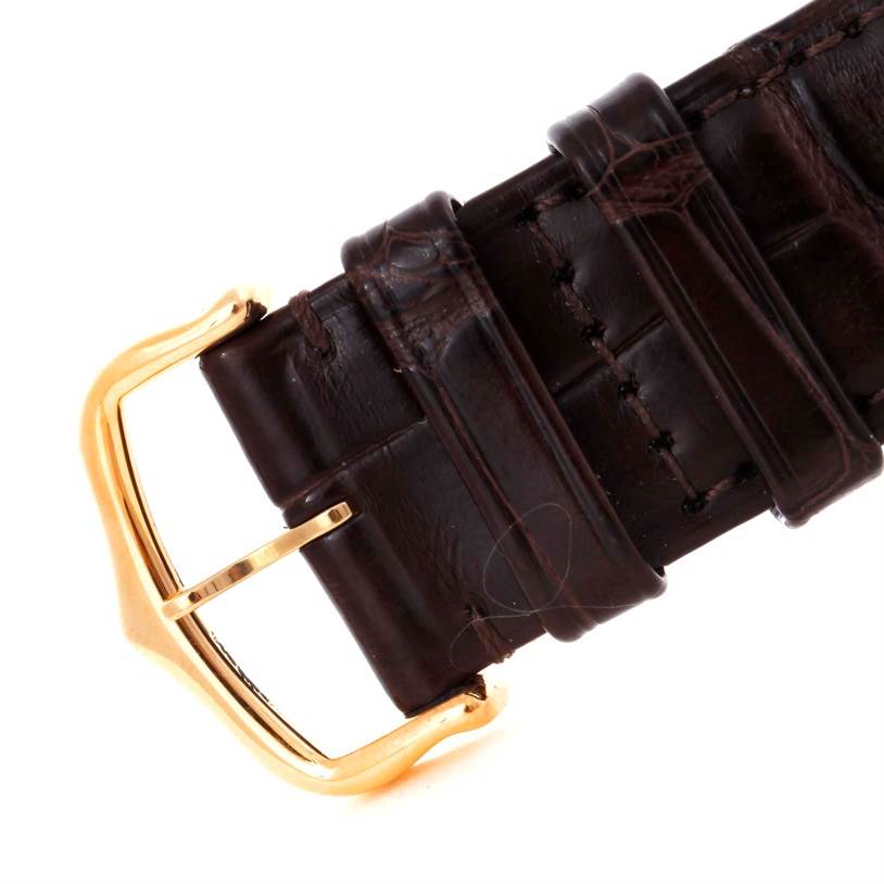 This image shows the brown leather strap and gold buckle of a Cartier Tank Solo W1018855 Men
s Steel and Gold (two tone) Silver Dial W1018855 Men
s Steel and Gold (two tone) Silver Dial watch, viewed close-up from an angled side perspective.