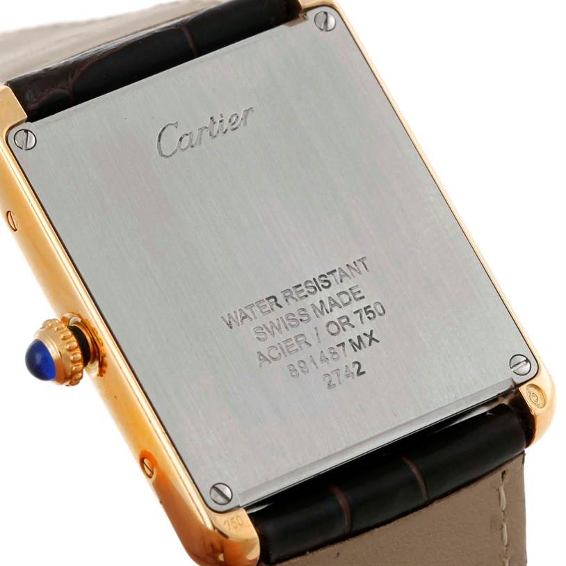 The image shows the back case, crown, and part of the strap of the Cartier Tank Solo W1018855 Men
s Steel and Gold (two tone) Silver Dial W1018855 Men
s Steel and Gold (two tone) Silver Dial watch.