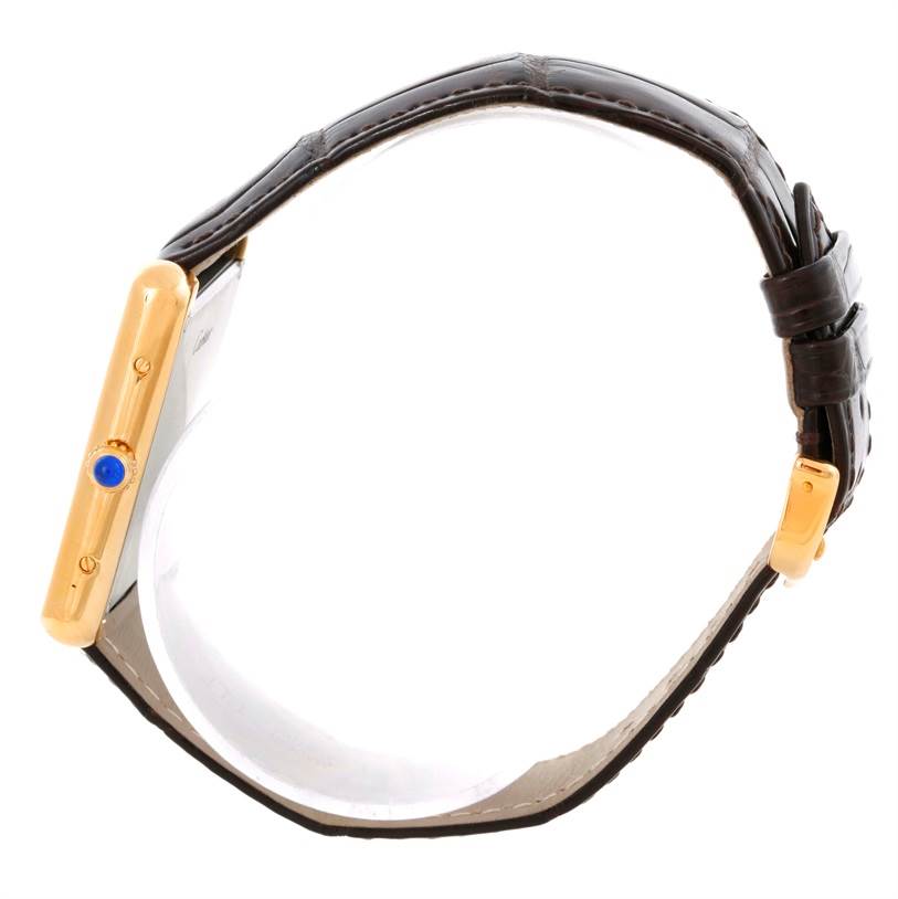 The image shows a side view of a Cartier Tank Solo W1018855 Men
s Steel and Gold (two tone) Silver Dial W1018855 Men
s Steel and Gold (two tone) Silver Dial watch, highlighting the crown and leather strap.