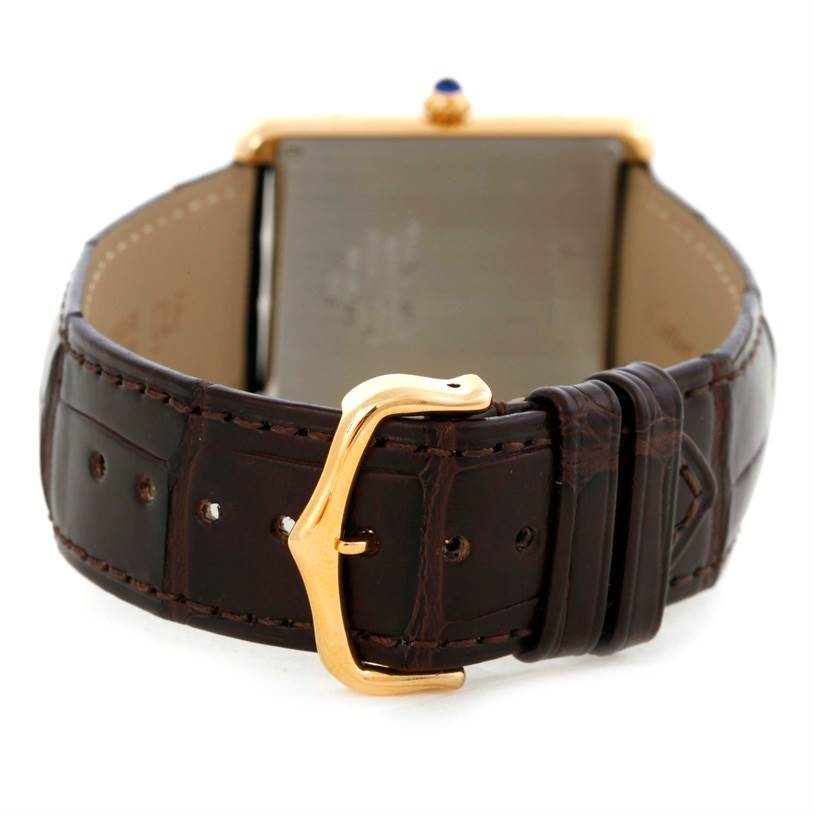 The image shows the back angle of the Cartier Tank Solo W1018855 Men
s Steel and Gold (two tone) Silver Dial W1018855 Men
s Steel and Gold (two tone) Silver Dial watch, highlighting its leather strap and gold buckle.