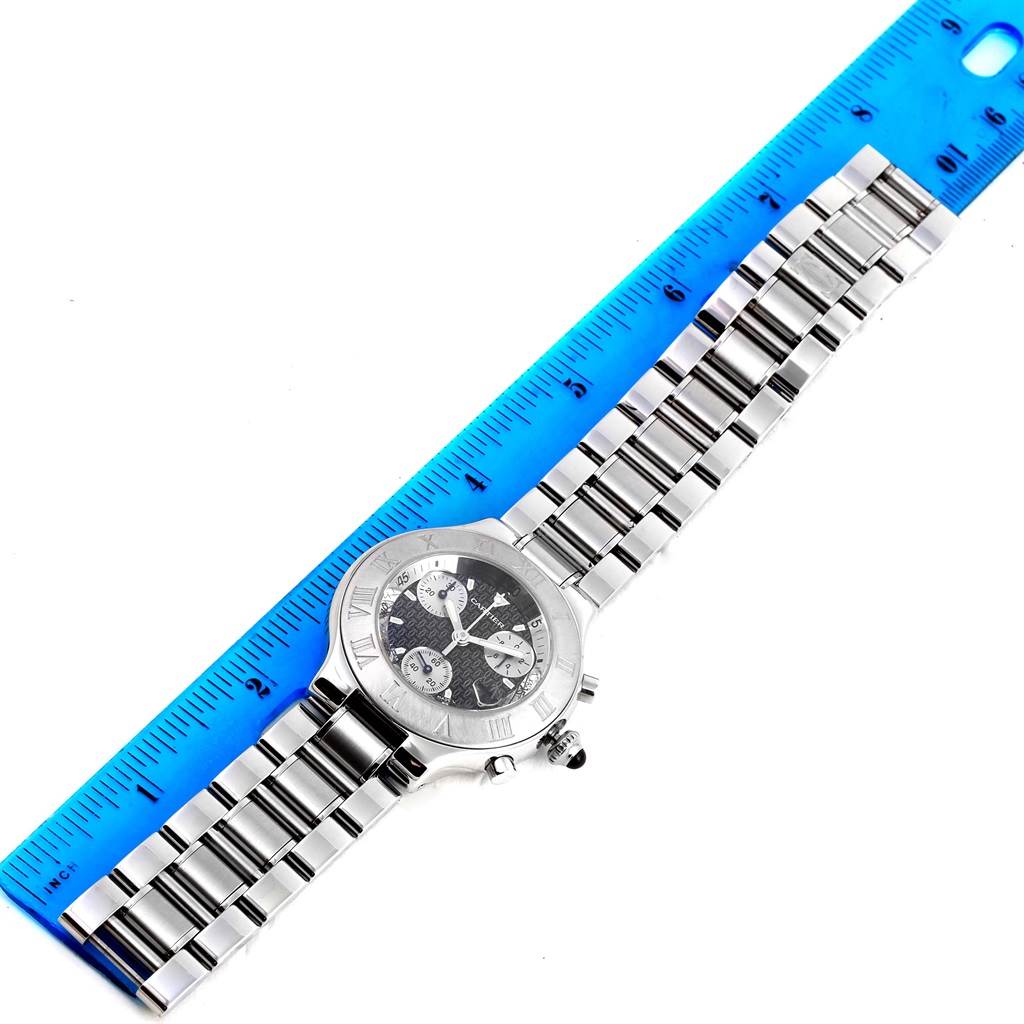 The Cartier Must 21 Chronoscaph W10172T2 Stainless Steel Black Dial W10172T2 Stainless Steel Black Dial watch is shown from a top-down angle with a ruler for scale.