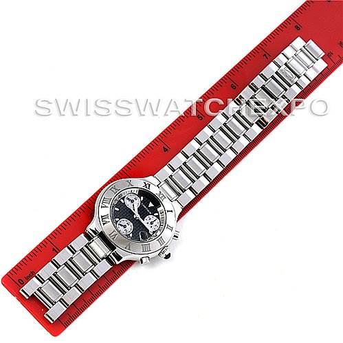 The Cartier Must 21 Chronoscaph W10172T2 Men
s Stainless Steel Black Dial W10172T2 Men
s Stainless Steel Black Dial watch is shown from above, displaying its face and full metal bracelet on a red ruler.