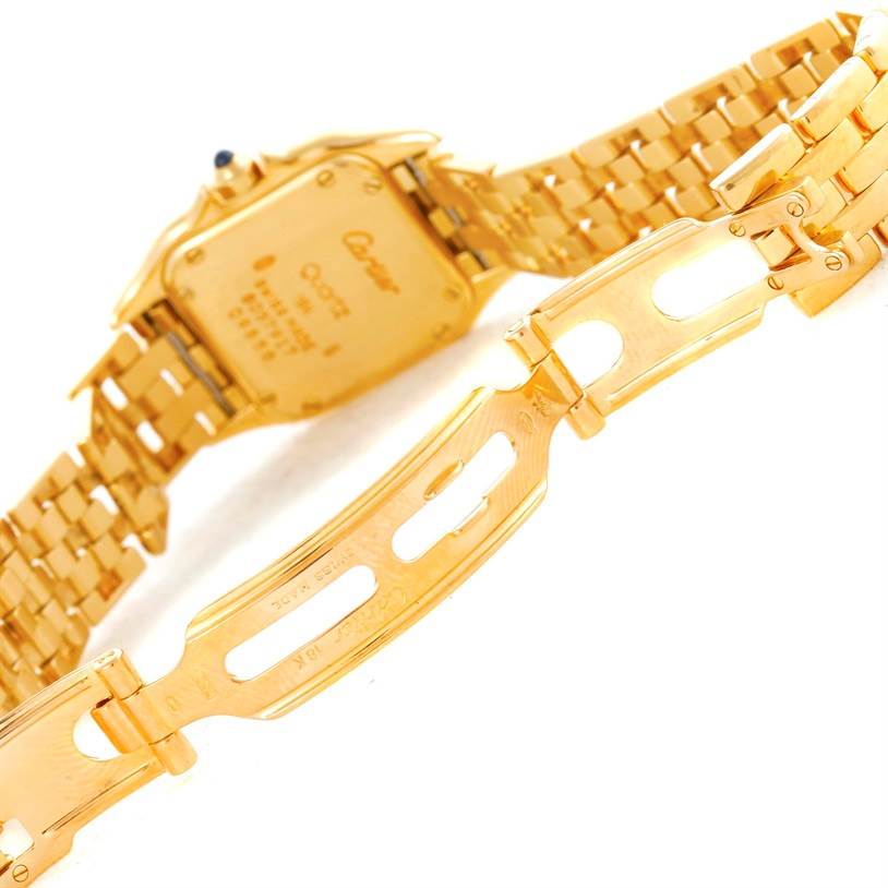 The image shows the back of a Cartier Panthere W25022B9 Women's Yellow Gold Silver Dial W25022B9 Women's Yellow Gold Silver Dial watch and its partly open gold bracelet clasp.