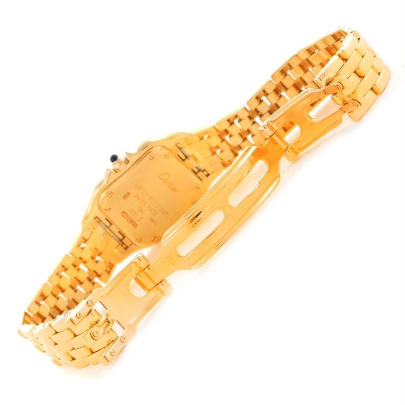 The image shows the back and clasp of a gold Panthère model watch by Cartier, with the band fully extended.