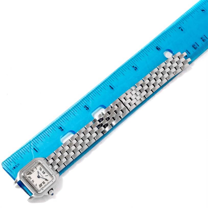 The image shows a Cartier Panthere W25033P5 Women
s Stainless Steel Silver Dial W25033P5 Women
s Stainless Steel Silver Dial watch laid beside a ruler, displaying its face and metal strap from a top-down angle.