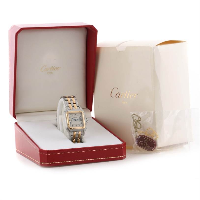 The image shows a Cartier Panthere W25028B8 Men
s Steel and Gold (two tone) Silver Dial W25028B8 Men
s Steel and Gold (two tone) Silver Dial watch in its open box with packaging and accessories nearby.