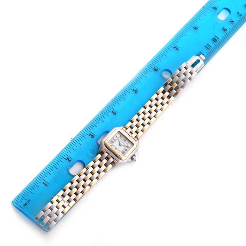 The image shows a top view of a Cartier Panthere W25029B6 Women's Stainless Steel Beige Dial W25029B6 Women's Stainless Steel Beige Dial watch with a blue ruler beside it.