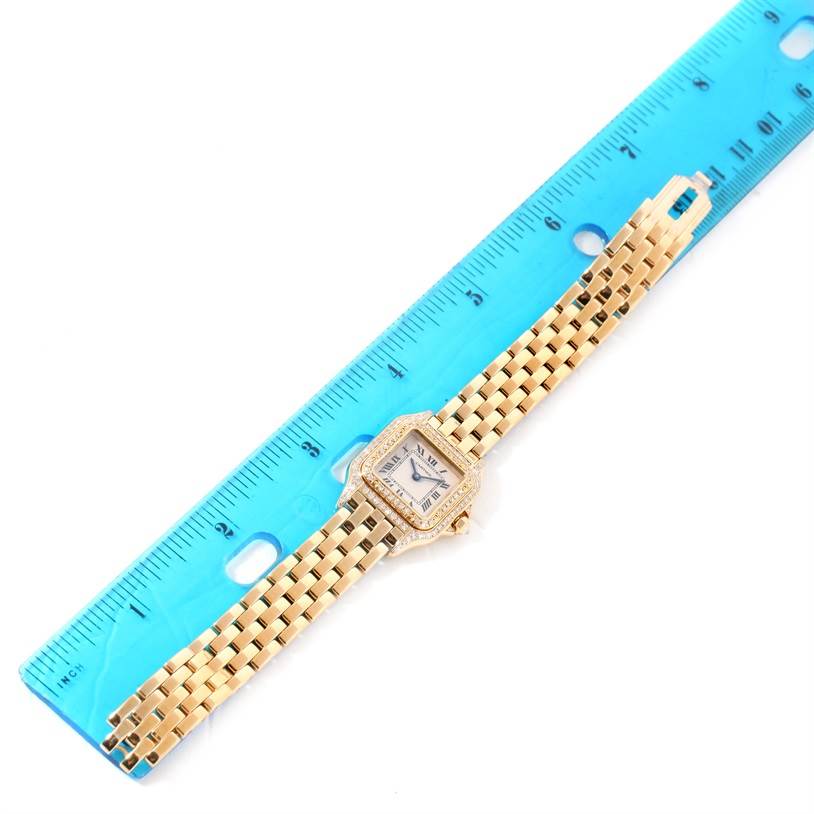 The Panthere model by Cartier is shown from a top-down angle alongside a blue ruler for scale.