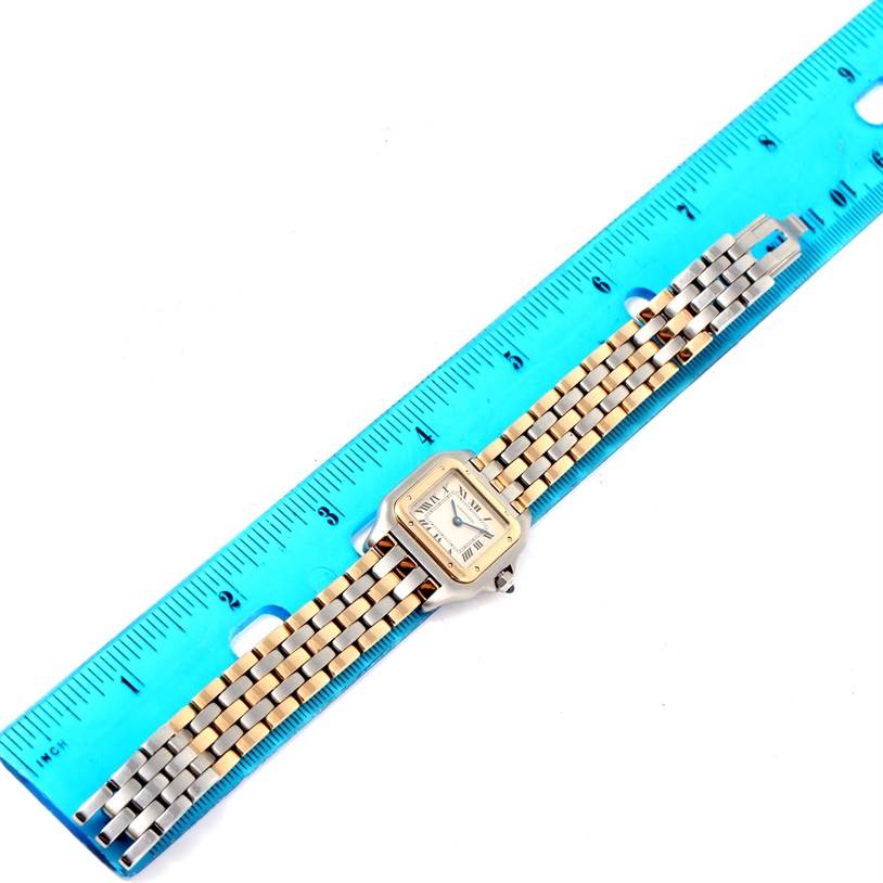 The image shows the entire Panthere model watch by Cartier from a top-down angle alongside a blue ruler for scale.