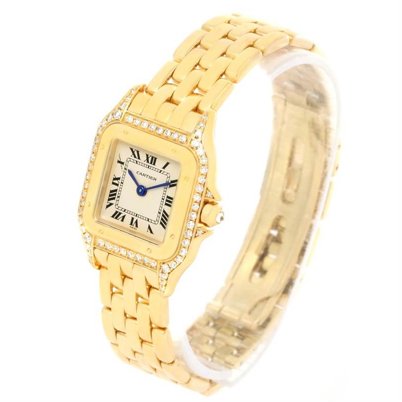The Cartier Panthere W25022B9 Women's Yellow Gold Silver Dial W25022B9 Women's Yellow Gold Silver Dial watch is shown at an angle displaying the face, bezel with diamonds, crown, and portions of the bracelet.