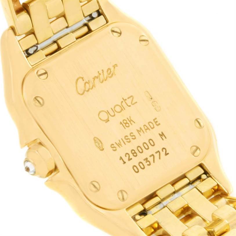 This image shows the case back of the Cartier Panthere W25022B9 Women's Yellow Gold Silver Dial W25022B9 Women's Yellow Gold Silver Dial model, highlighting its inscriptions and bracelet attachment.