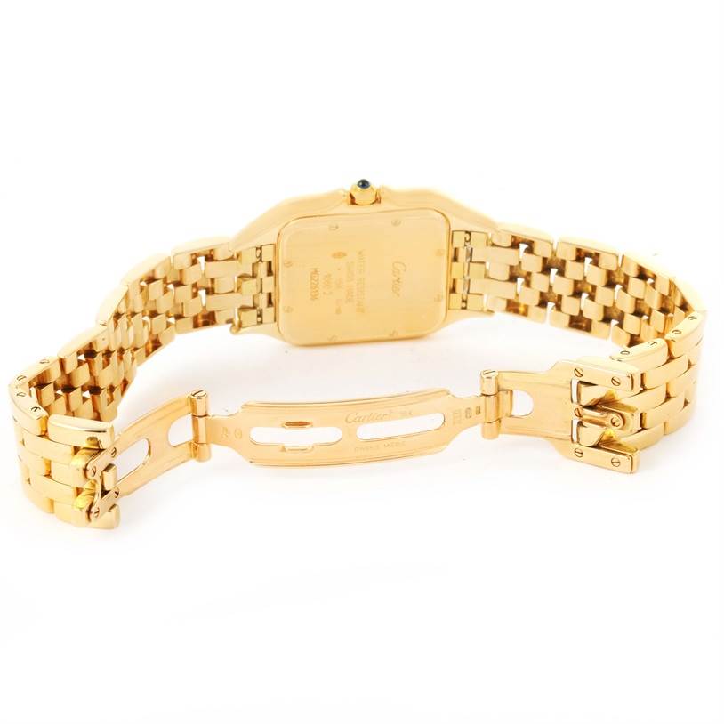 The image shows the back view of a Cartier Panthere W25014B9 Yellow Gold Silver Dial W25014B9 Yellow Gold Silver Dial model watch, focusing on the case back and partially opened bracelet clasp.