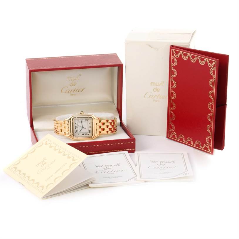 The Cartier Panthere W25014B9 Yellow Gold Silver Dial W25014B9 Yellow Gold Silver Dial watch is displayed from a front angle alongside its red box, white outer box, and accompanying booklets.