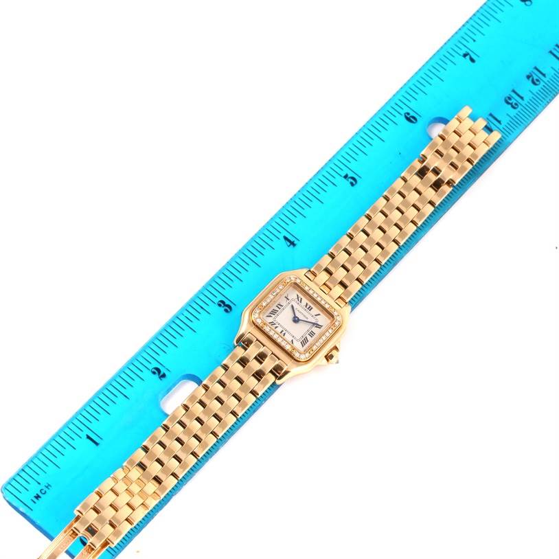 The image shows a Cartier Panthere WF3070B9 Women's Yellow Gold Silver Dial WF3070B9 Women's Yellow Gold Silver Dial watch laid flat next to a blue ruler for measurement.