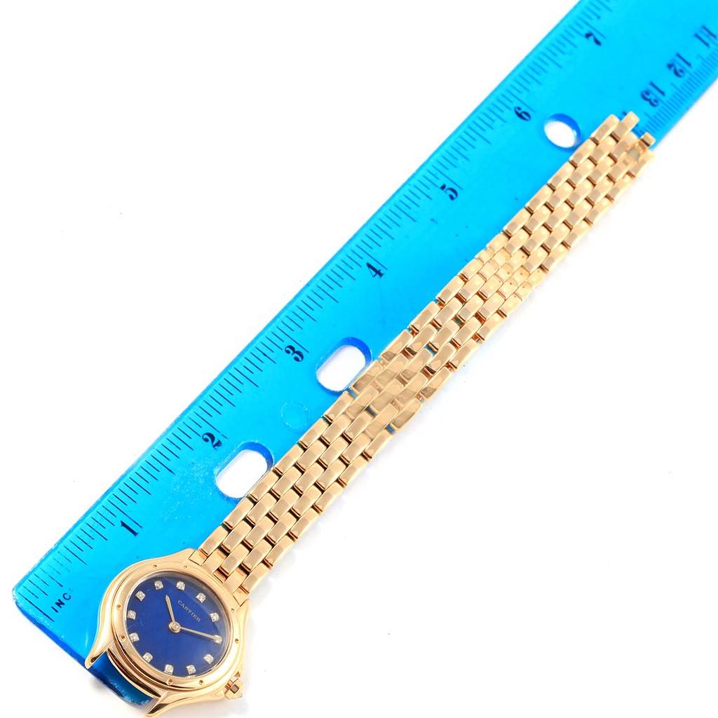 The image shows a Panthere model by Cartier watch laying flat next to a ruler for measurement.