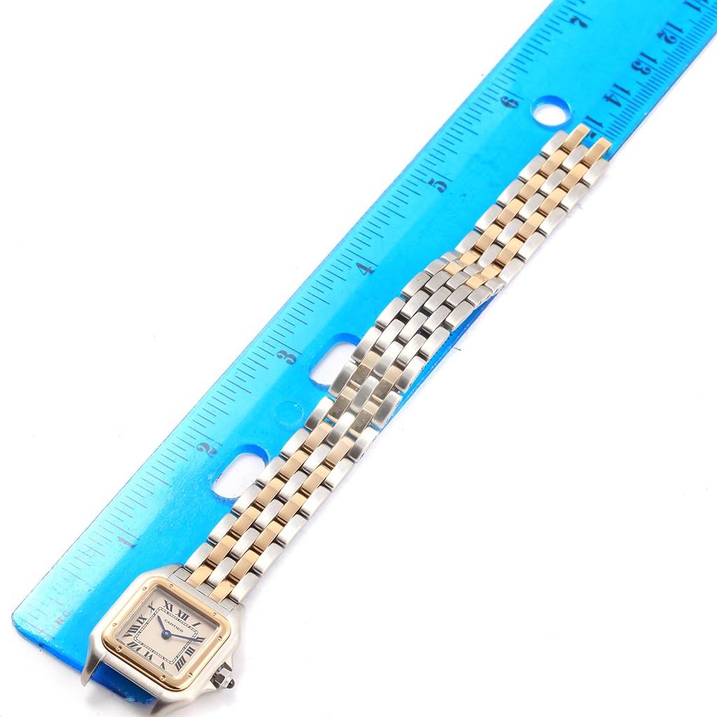 The image shows a Cartier Panthere W25029B6 Women
s Stainless Steel Silver Dial W25029B6 Women
s Stainless Steel Silver Dial watch laid out flat next to a blue ruler, displaying its dial and bracelet.