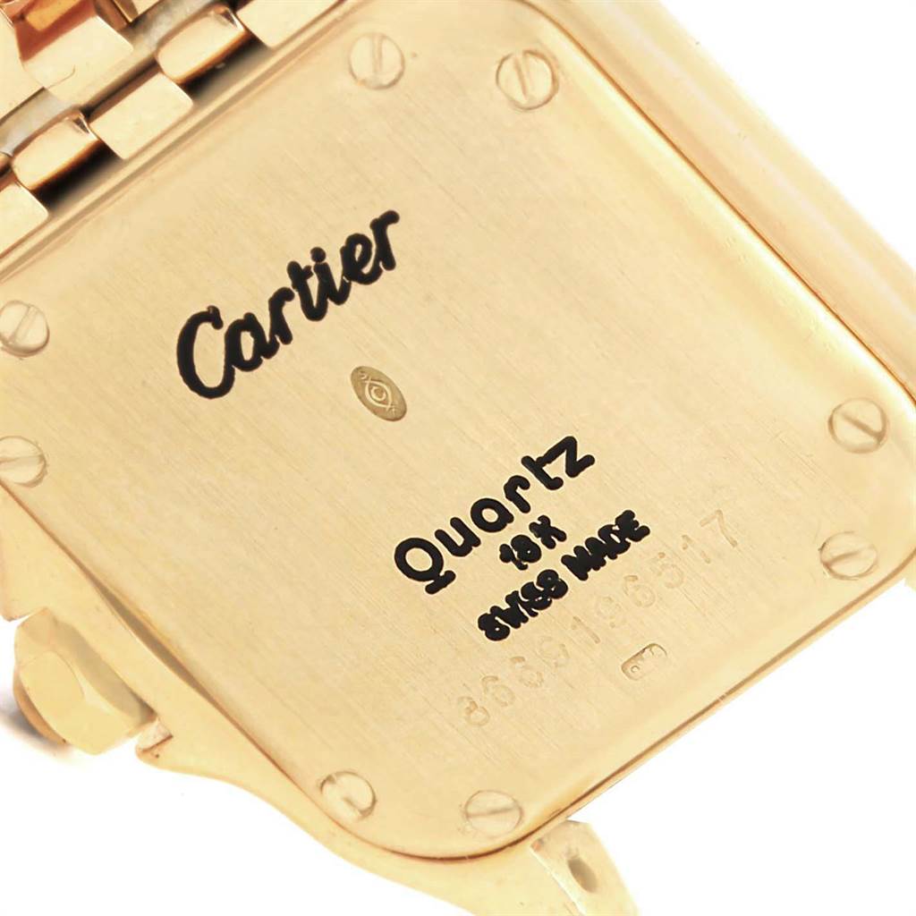 This image shows the back case of a Panthere model Cartier watch, highlighting its engravings and screws.