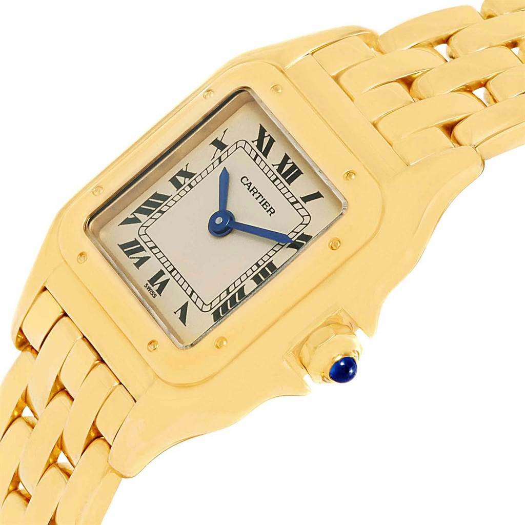 This Cartier Panthere W25022B9 Women's Yellow Gold Beige Dial W25022B9 Women's Yellow Gold Beige Dial model watch is shown at an angled view, highlighting the watch face, bezel, bracelet, and crown with a blue gem.