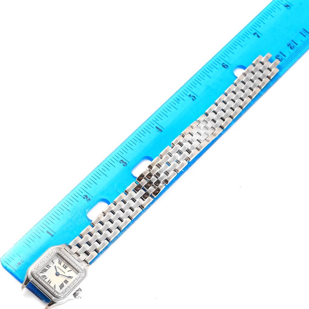 The image shows a Panthere model by Cartier from a top-down angle, displaying its face and metal bracelet next to a blue ruler.