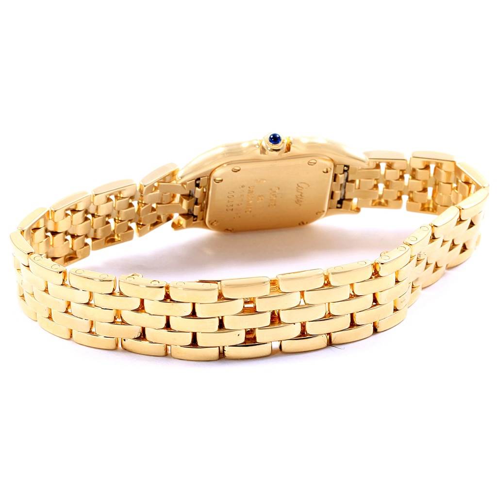 The image shows the back view of a Panthere model watch by Cartier, highlighting the gold bracelet and case back.