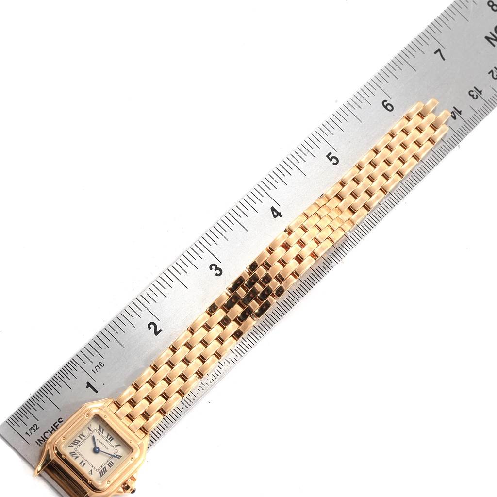 The image shows the face and bracelet of a Cartier Panthere W25022B9 Women's Yellow Gold Silver Dial W25022B9 Women's Yellow Gold Silver Dial watch next to a ruler for measurement.