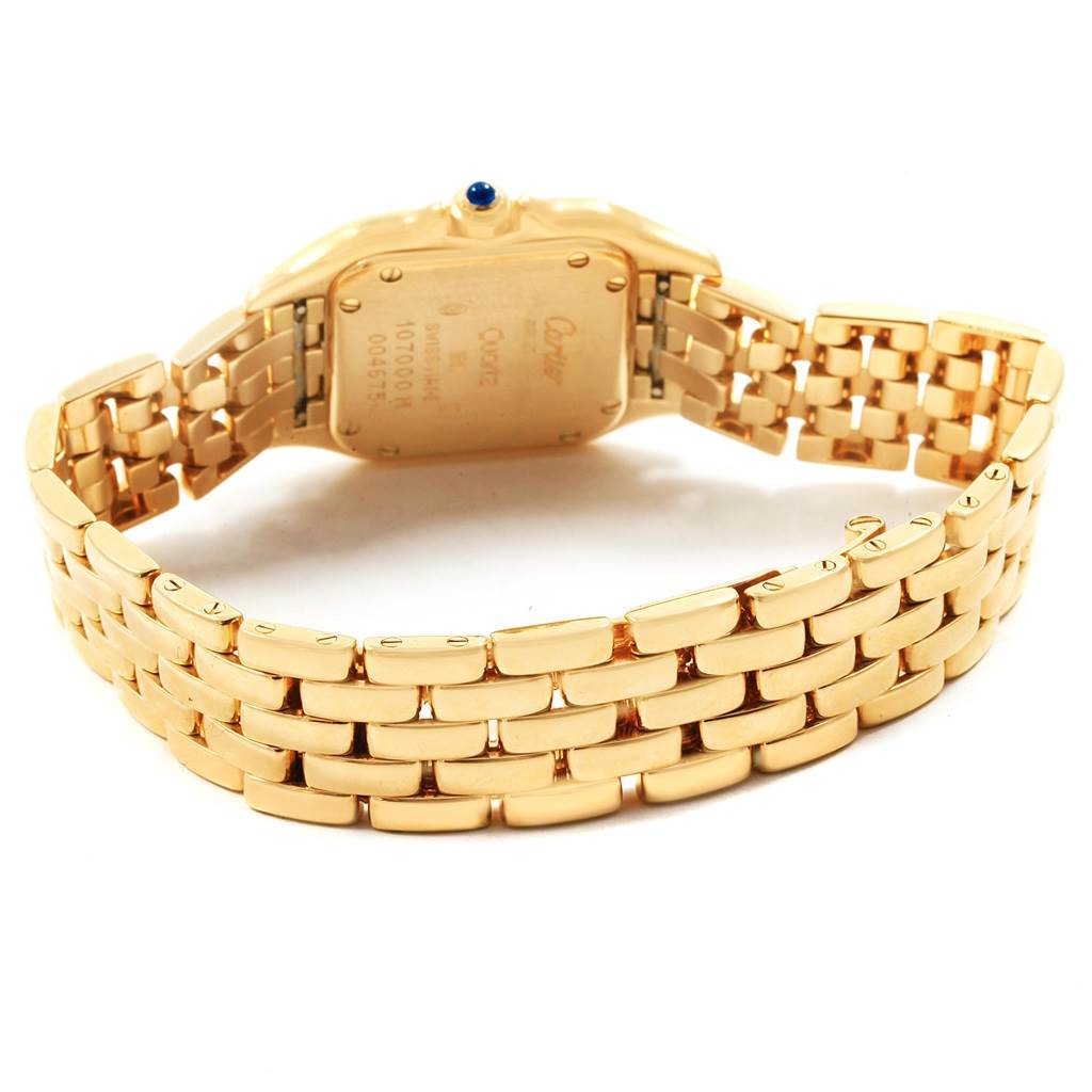 The image shows the back view of a Cartier Panthere W25022B9 Women's Yellow Gold Silver Dial W25022B9 Women's Yellow Gold Silver Dial watch, highlighting its gold bracelet and backside of the watch case.