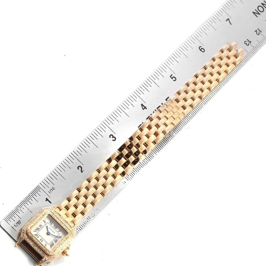 The image shows a Cartier Panthere WF3072B9 Women's Yellow Gold Silver Dial WF3072B9 Women's Yellow Gold Silver Dial watch facing up, with the full length of its gold bracelet next to a ruler for scale.