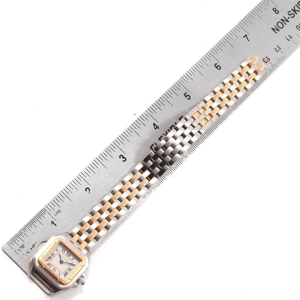 This image shows the front view of a Cartier Panthere W25029B6 Women
s Stainless Steel Silver Dial W25029B6 Women
s Stainless Steel Silver Dial watch with the face and part of the bracelet, alongside a ruler for scale.