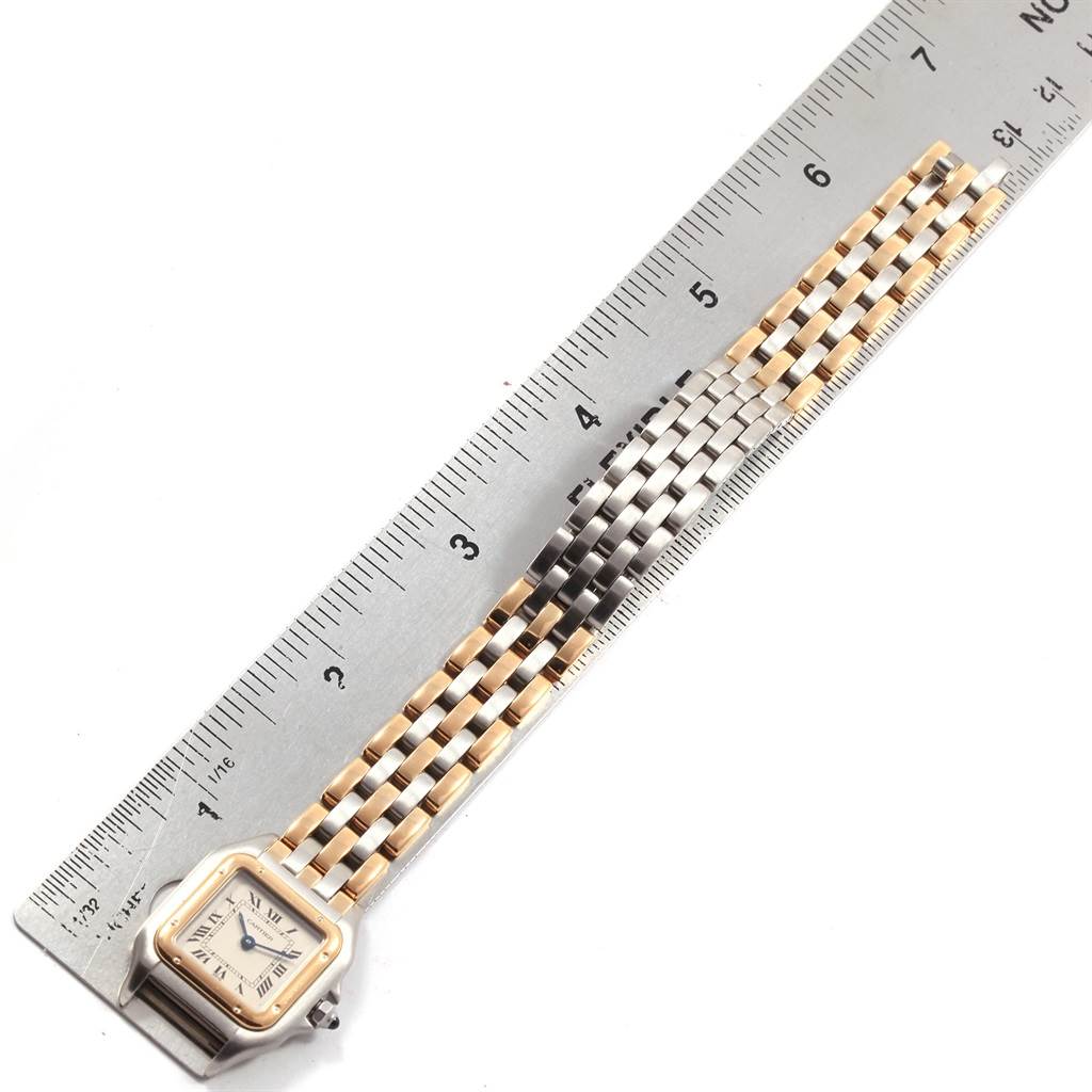 The image shows a Panthere model by Cartier watch laid flat with a ruler, highlighting the full face and band.