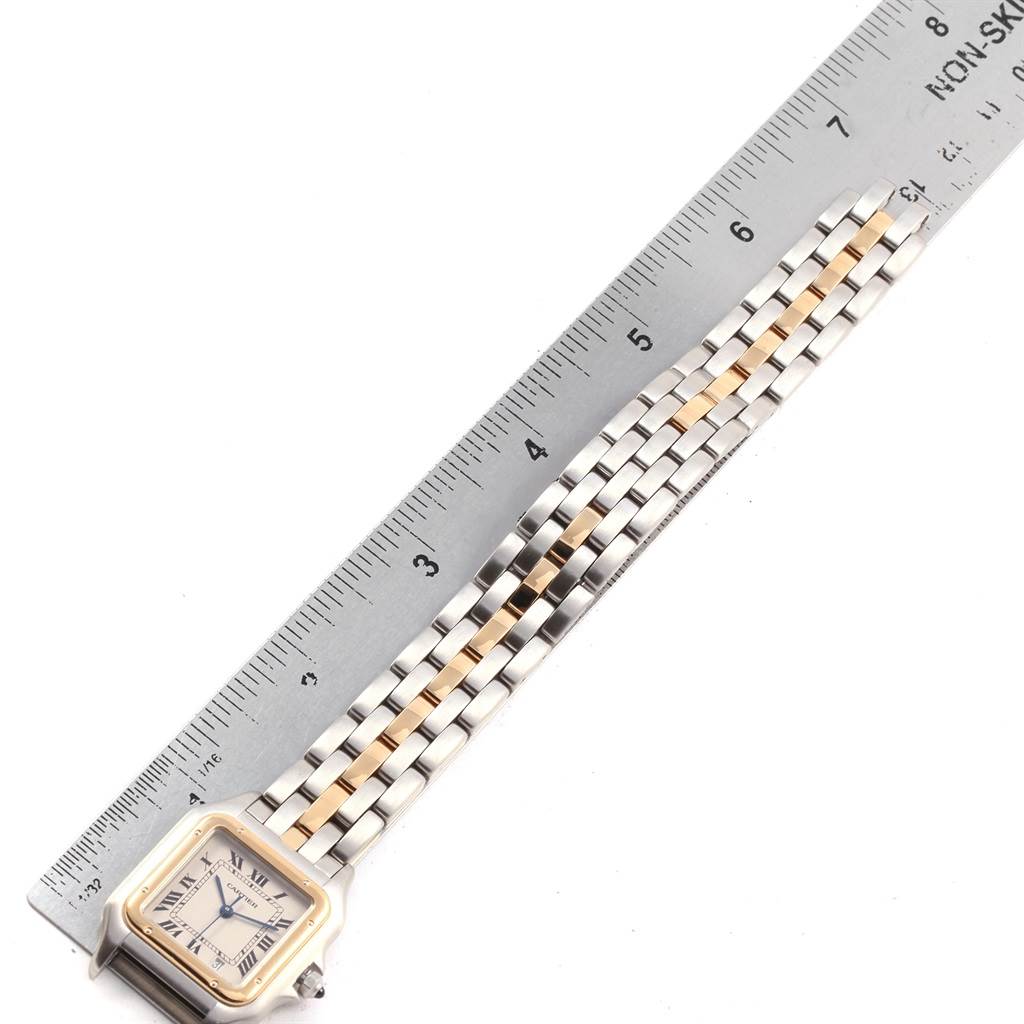 The image shows a Cartier Panthere W25028B5 Men's Steel and Gold (two tone) Silver Dial W25028B5 Men's Steel and Gold (two tone) Silver Dial model watch laid flat next to a ruler, displaying the face and part of the bracelet.