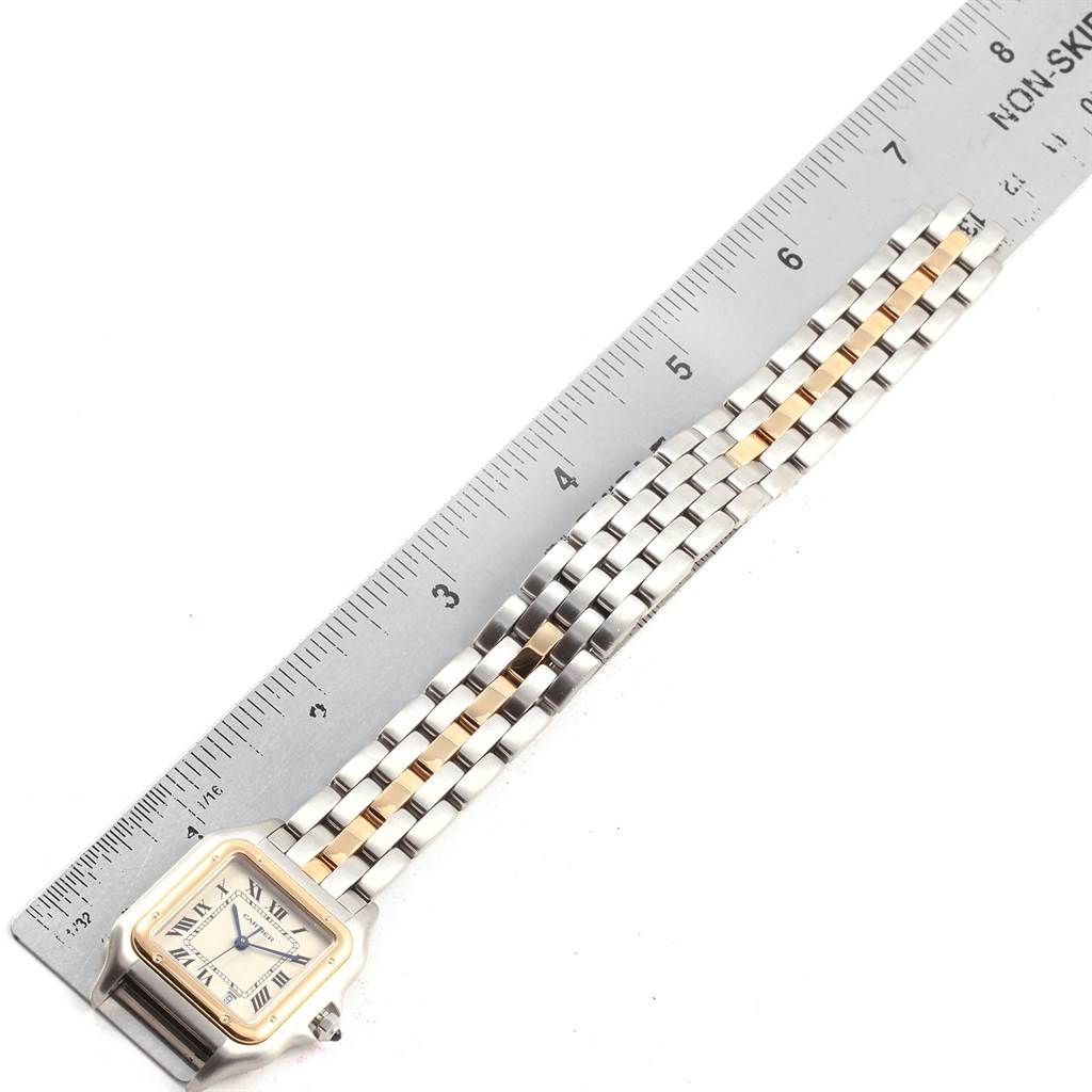 The image shows a full-length view of a Panthere model Cartier watch, including the face and bracelet, laid next to a ruler.