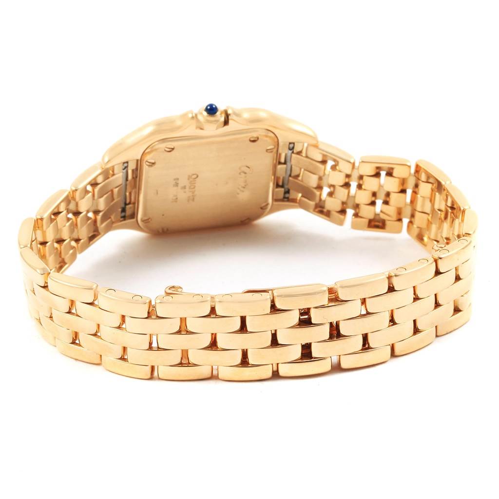 The image shows the back view of a Cartier Panthère watch, highlighting its gold bracelet and case back.