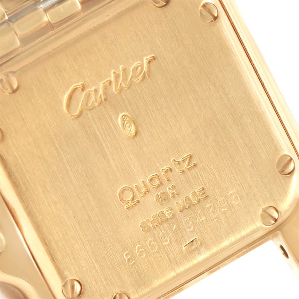 This image shows a close-up of the back case of a Cartier Panthere W25022B9 Women's Yellow Gold Silver Dial W25022B9 Women's Yellow Gold Silver Dial watch with engraved details.