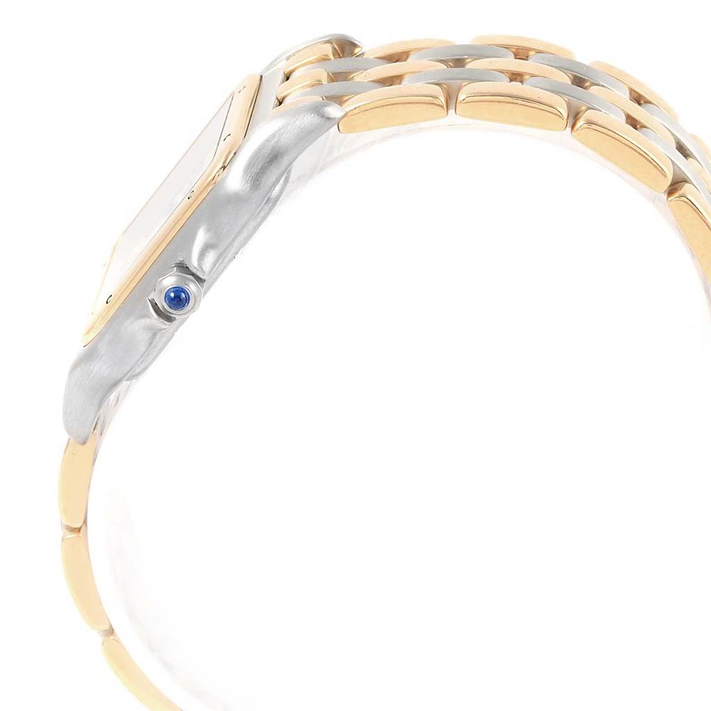 This image shows a side profile of the Panthère model by Cartier, highlighting the bezel, crown with a blue stone, and bracelet links.