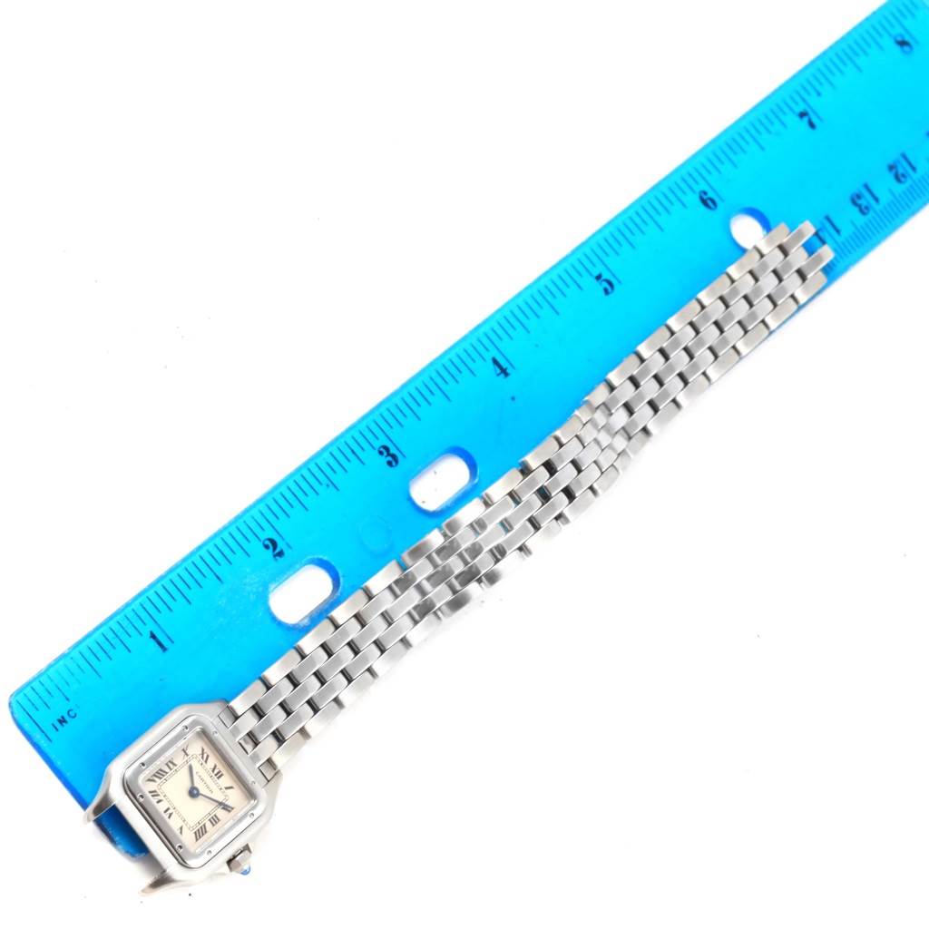 The Cartier Panthere W25033P5 Women
s Stainless Steel Silver Dial W25033P5 Women
s Stainless Steel Silver Dial watch is shown with its face, bracelet, and part of a blue ruler for scale.