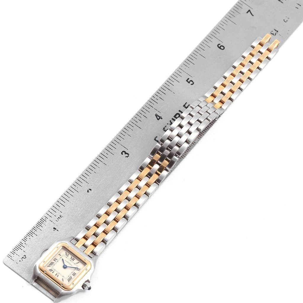 The Cartier Panthere W25029B6 Women
s Stainless Steel Silver Dial W25029B6 Women
s Stainless Steel Silver Dial watch is shown from a top-down angle, including the face, bracelet, and ruler for measurement.