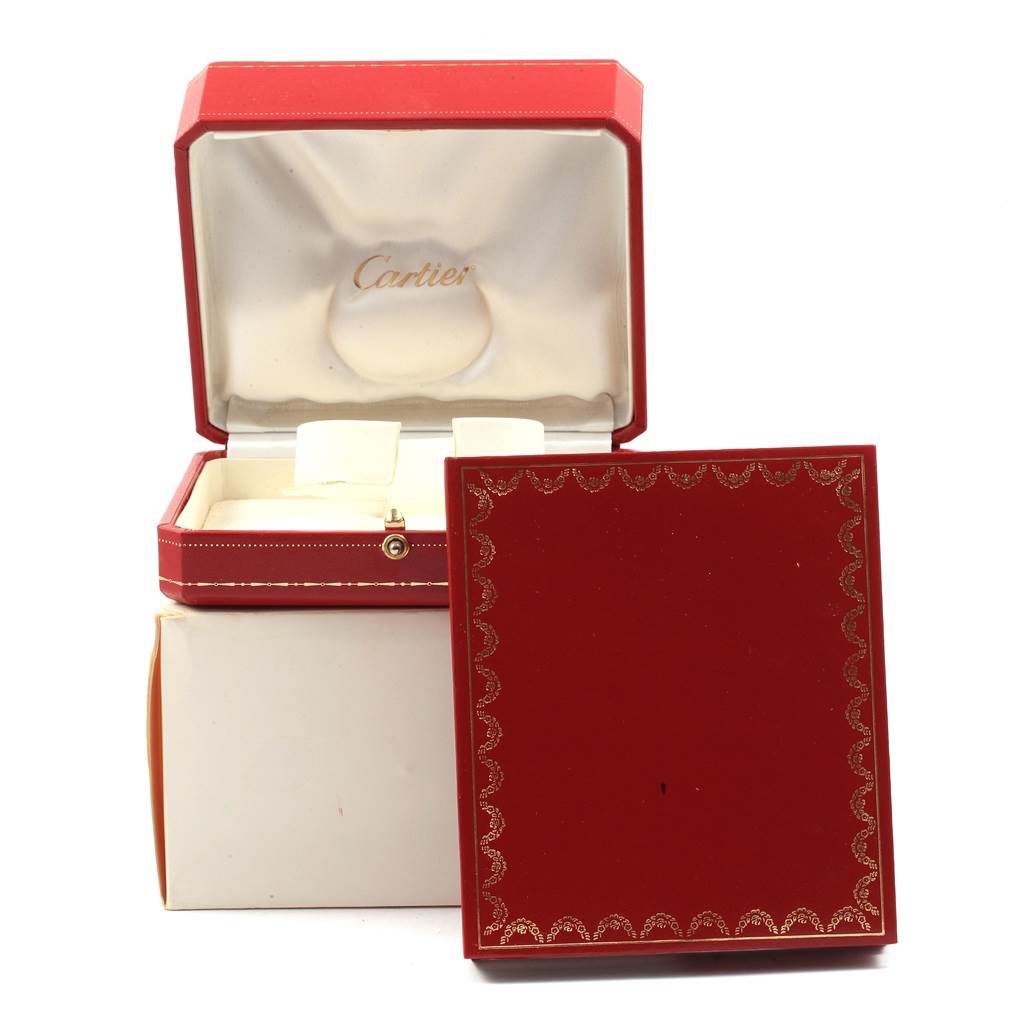 The image shows an open red Cartier Panthere W25029B6 Women
s Stainless Steel Silver Dial W25029B6 Women
s Stainless Steel Silver Dial watch box with the lid and a cushion for the watch.