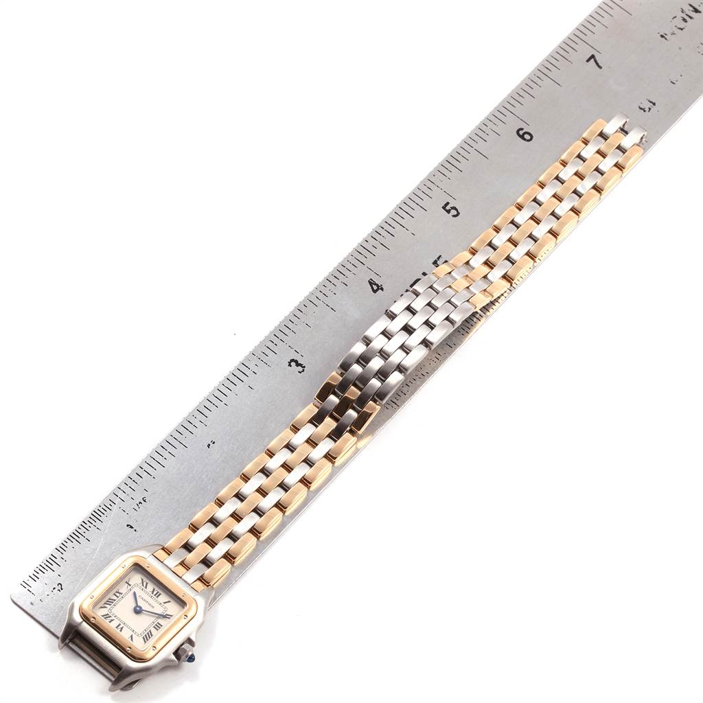 The image shows a Cartier Panthere W25029B6 Women
s Stainless Steel Silver Dial W25029B6 Women
s Stainless Steel Silver Dial watch with its gold and silver bracelet laid flat next to a ruler for measurement.