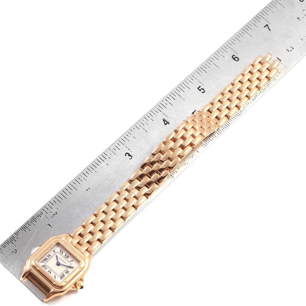 The image shows a Panthere model by Cartier laying flat alongside a ruler, displaying the watch face and the full length of the metal bracelet.