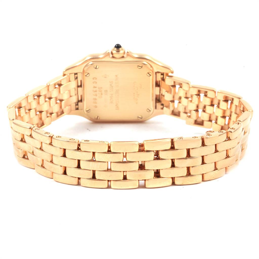 The image shows the back view of a Panthère de Cartier watch, with emphasis on the case back and gold bracelet.